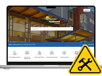 Computer showing Haldimand County website with maintenance sign
