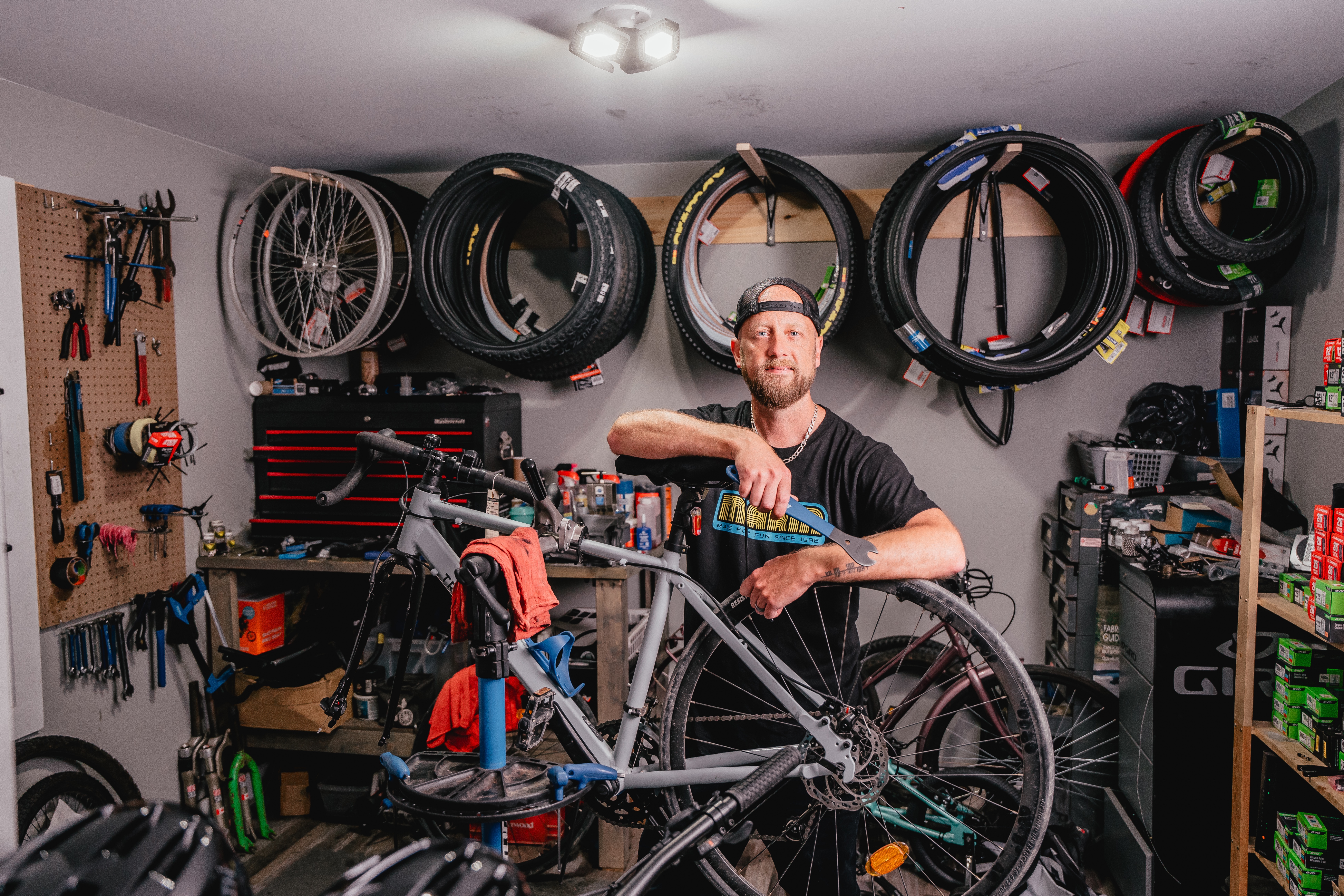 Business owner holding wrench infront of bike