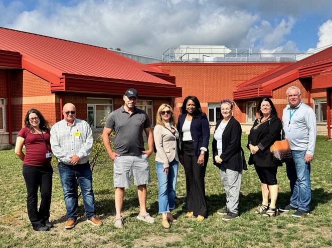 Group photo of Haldimand Council, staff, federal and provincial representatives in front of Grandview Lodge.