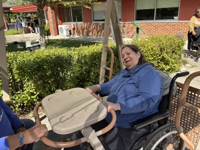 Grandview Lodge resident in wheelchair using a wheelchair accessible swing