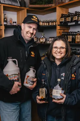 People holding maple syrup
