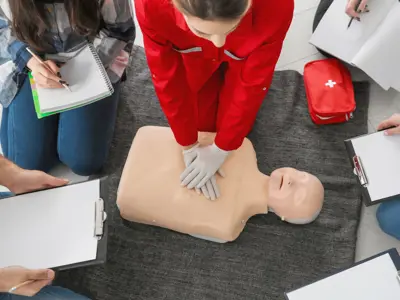 Students taking notes during a CPR demonstration