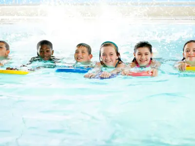 Kids in a pool on kickboards