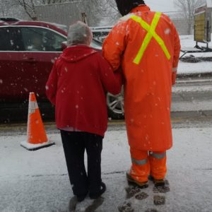 Water Field staff assisting resident crossing the street