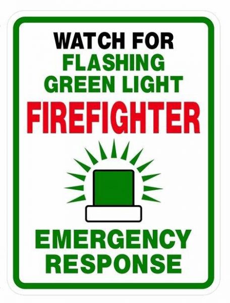 A sign that reads Watch For Green Flashing Light - Firefighter - Emergency Response