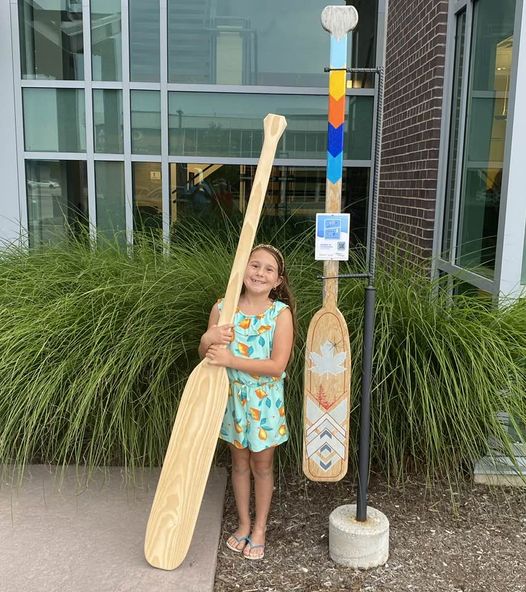 A girl holding a paddle
